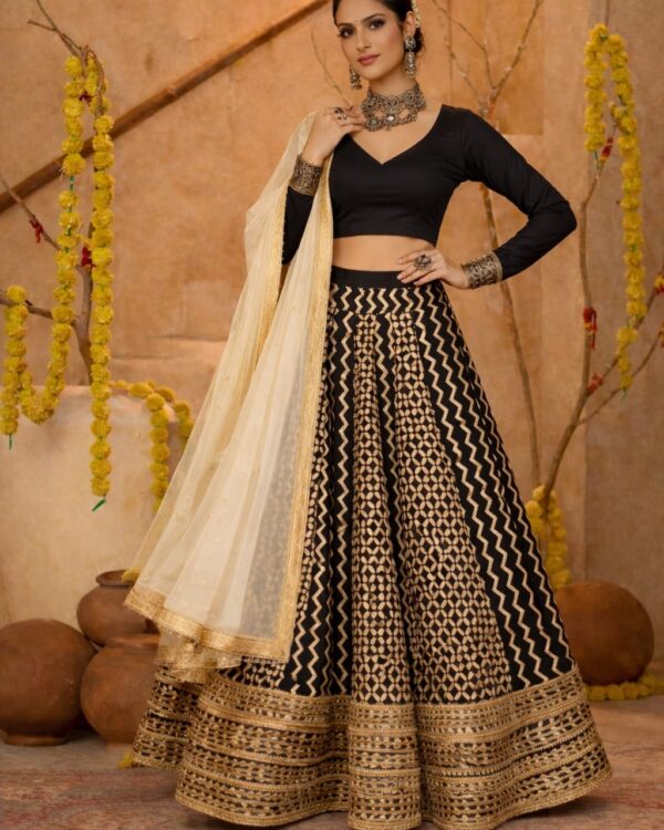 Black cotton silk blouse with ivory geometric printed gota lace lehenga paired with an ivory embroidered organza dupatta