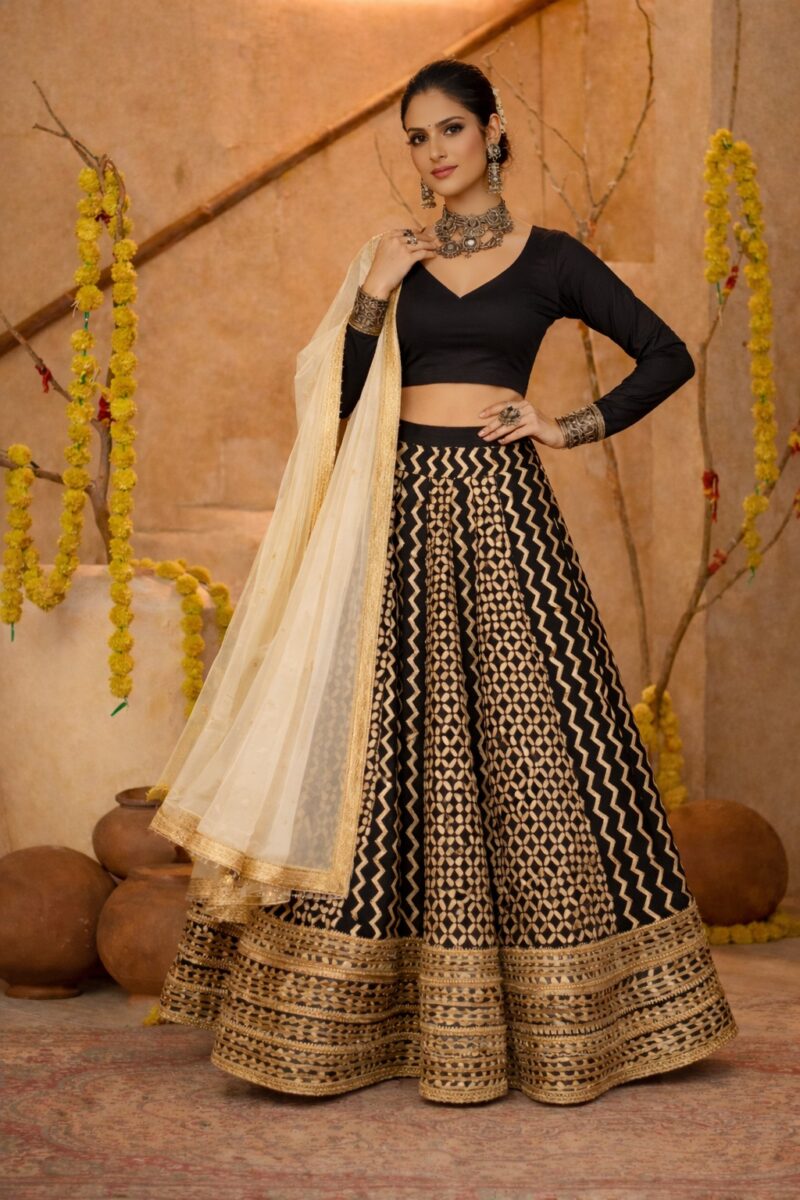 Black cotton silk blouse with ivory geometric printed gota lace lehenga paired with an ivory embroidered organza dupatta